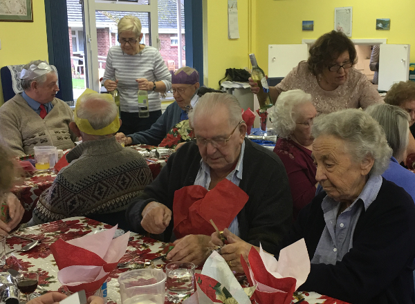 Volunteers wait on table at the Christmas lunch